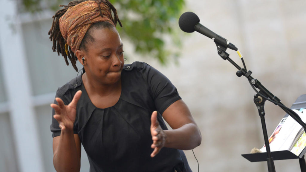 Photo of author Bibish Marie-Louise Mumbu at a microphone